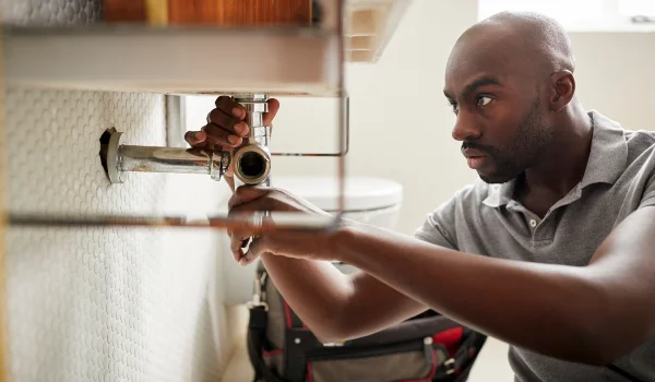 a male plumber fixing a pipe connection from Emergency Plumber Austin in Austin, TX 